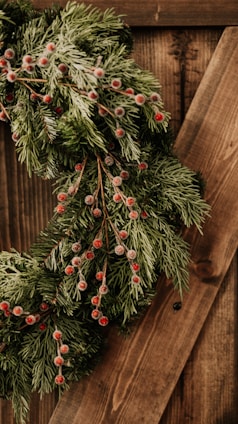 Handcrafted Christmas wreath made from natural, sustainable materials with vibrant red berries.