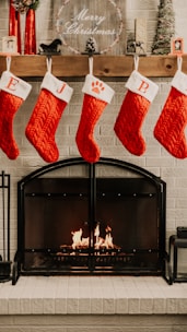 Eco-friendly Christmas stockings hanging by a fireplace, decorated with cheerful patterns.