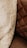 A close-up view of a textured fabric and a quilted leather surface. The fabric appears soft and fluffy, suggesting a warm and cozy material, while the leather surface has a rich brown tone with visible stitching in a diamond pattern.