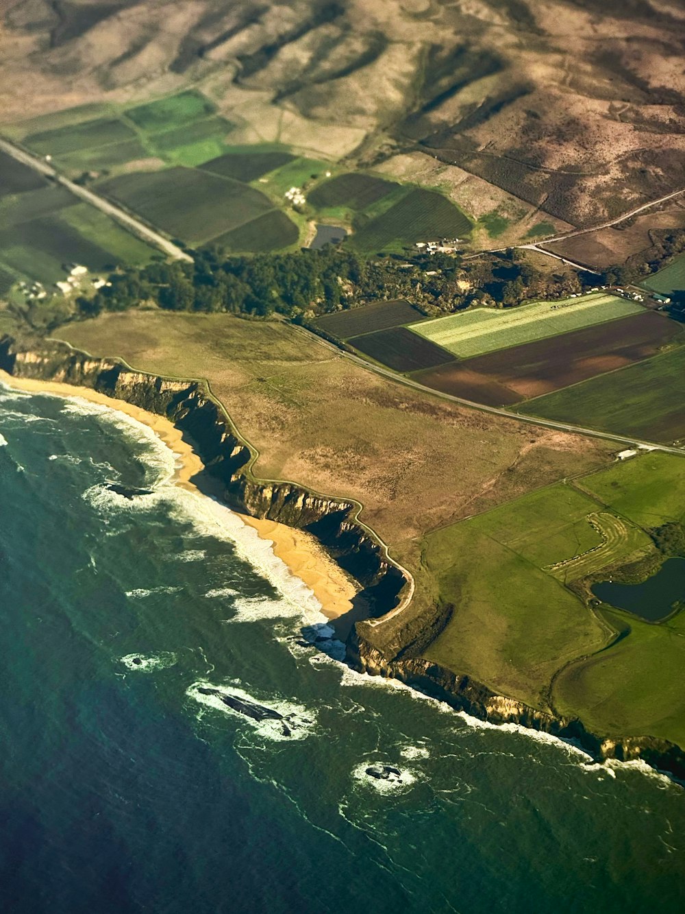 an aerial view of the ocean and land