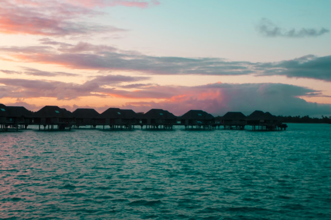 a body of water that has some houses on it, Bora bora
