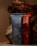 Two toothpaste tubes are positioned against a backdrop of textured, bark-like material. The tube in the foreground is blue and prominently displays the brand name 'before' and the text 'Whitening.' The tube behind it is red with similar branding.