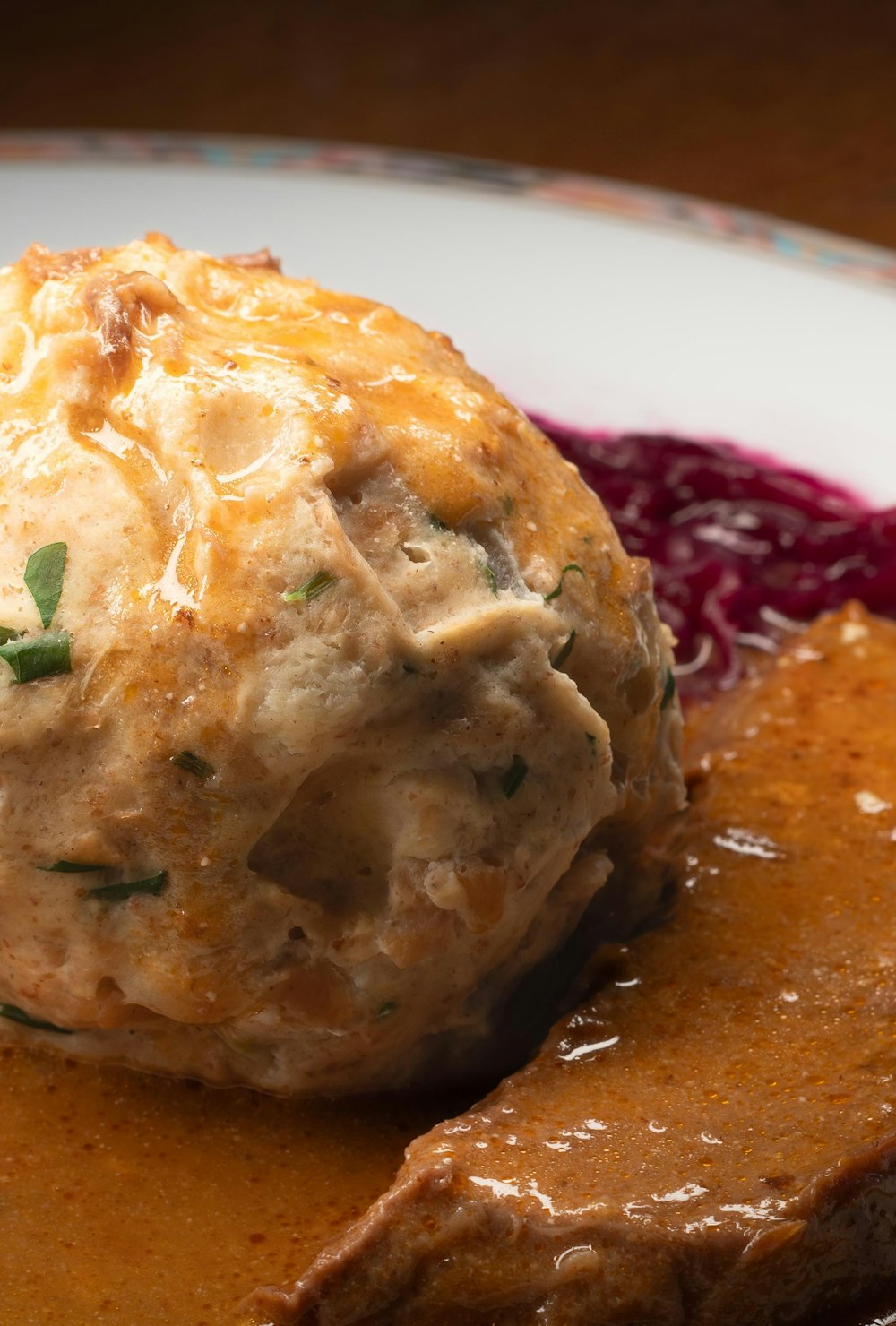 a close up of a plate of food with meat and gravy