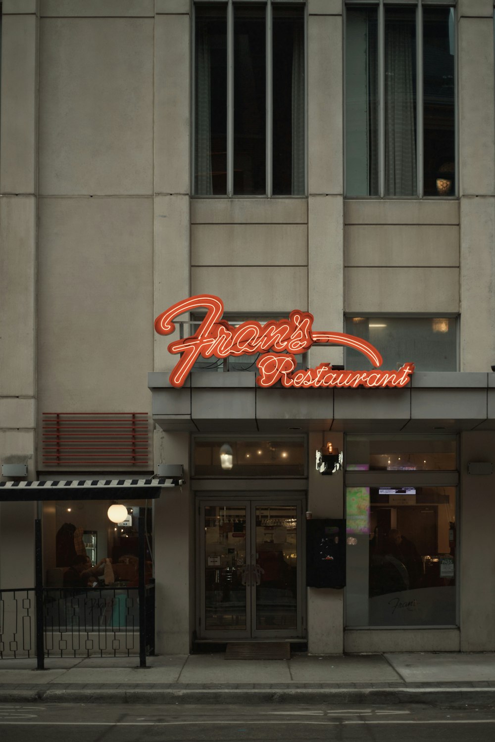 a restaurant with a neon sign on the front of it