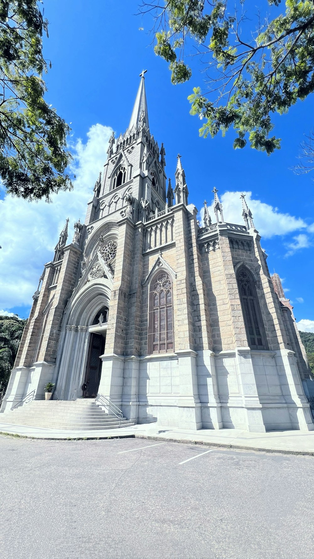 a large church with a tall steeple on a sunny day