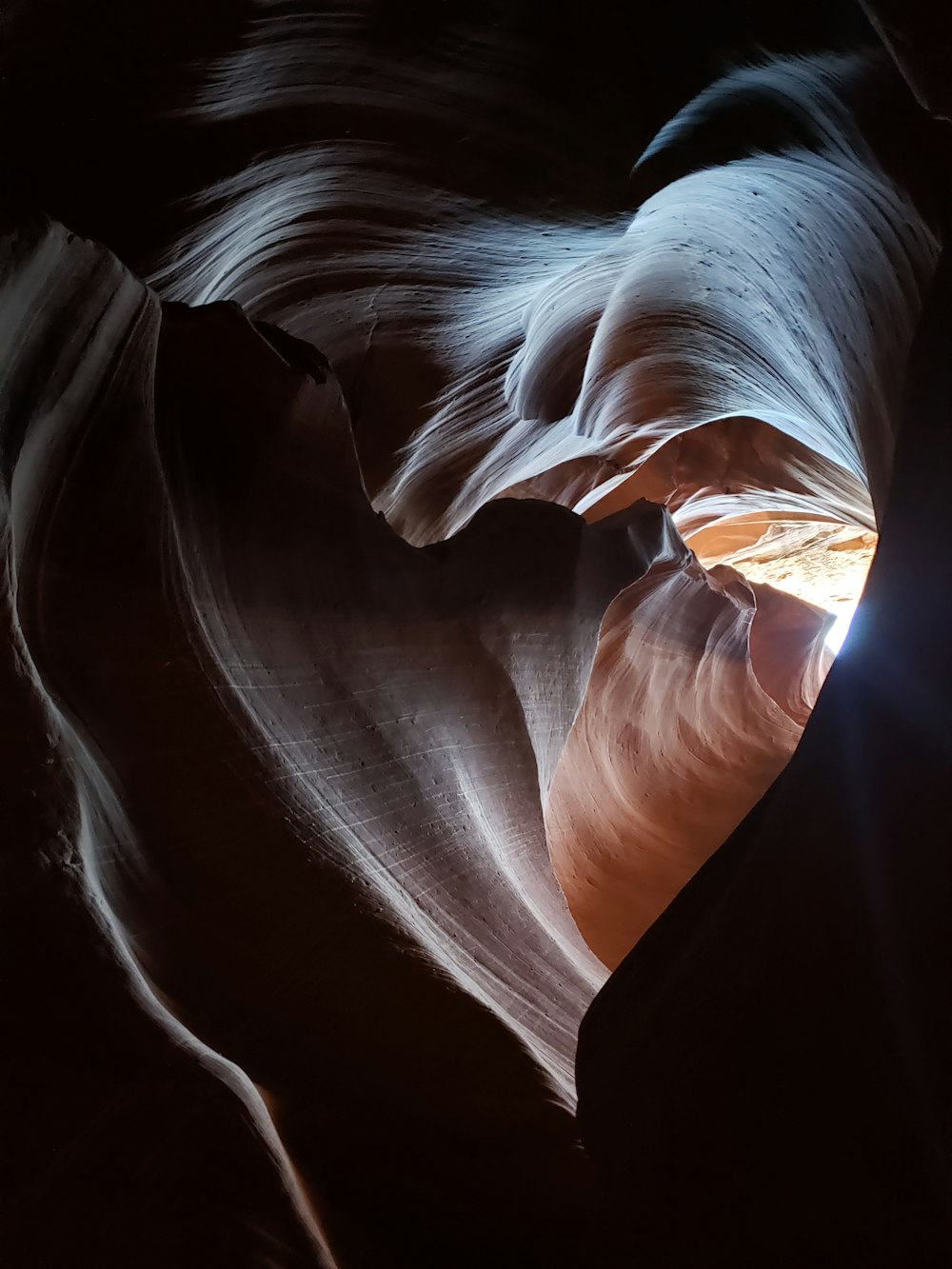 a light shines through a slot in a canyon
