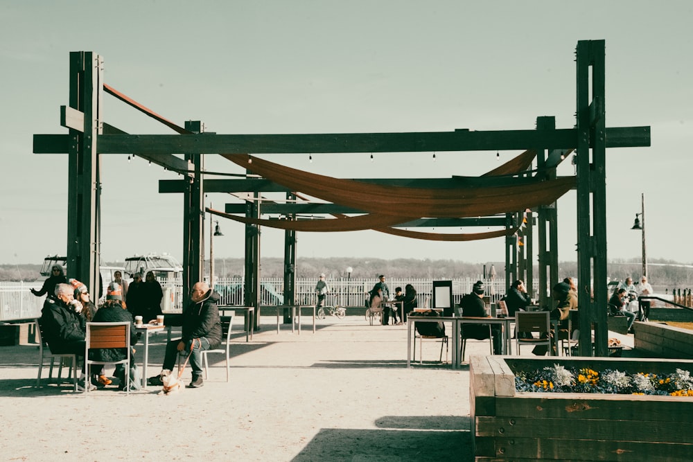 a group of people standing around a wooden structure