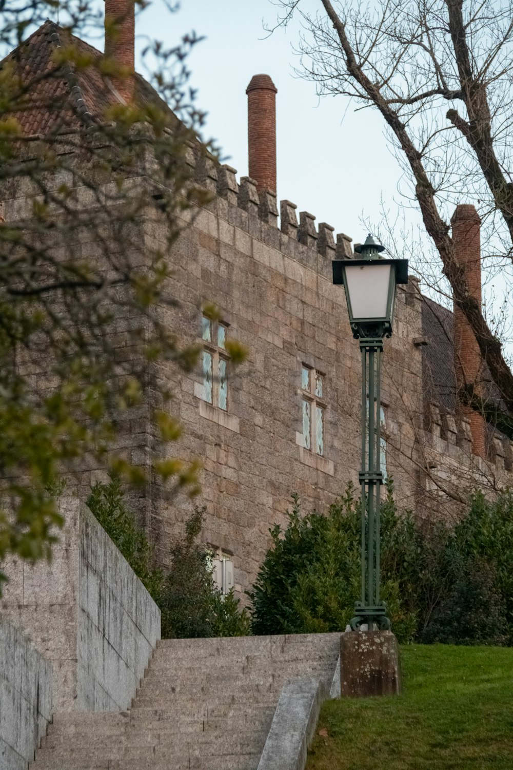a street light sitting next to a stone building