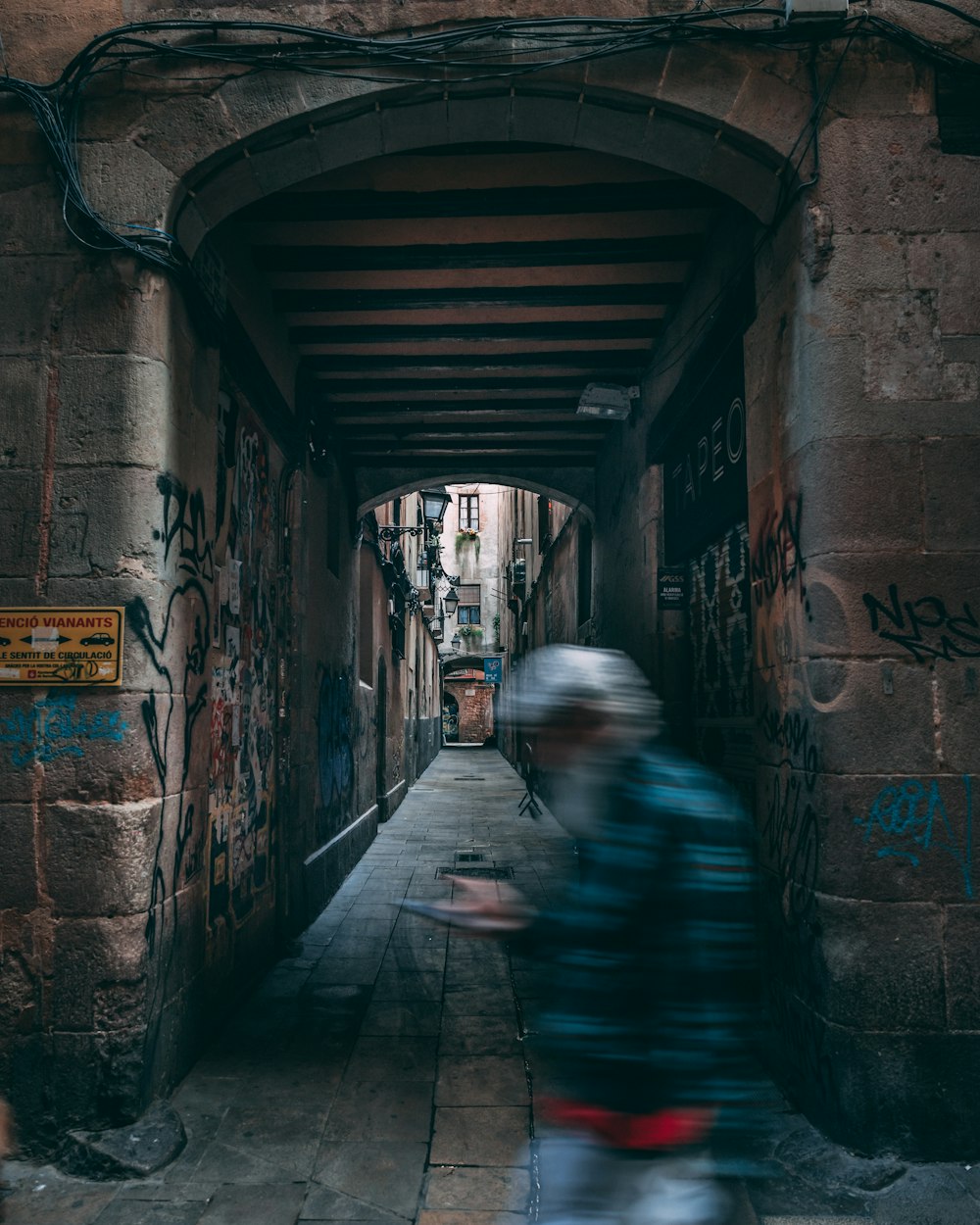 a blurry photo of a person riding a bike through a tunnel