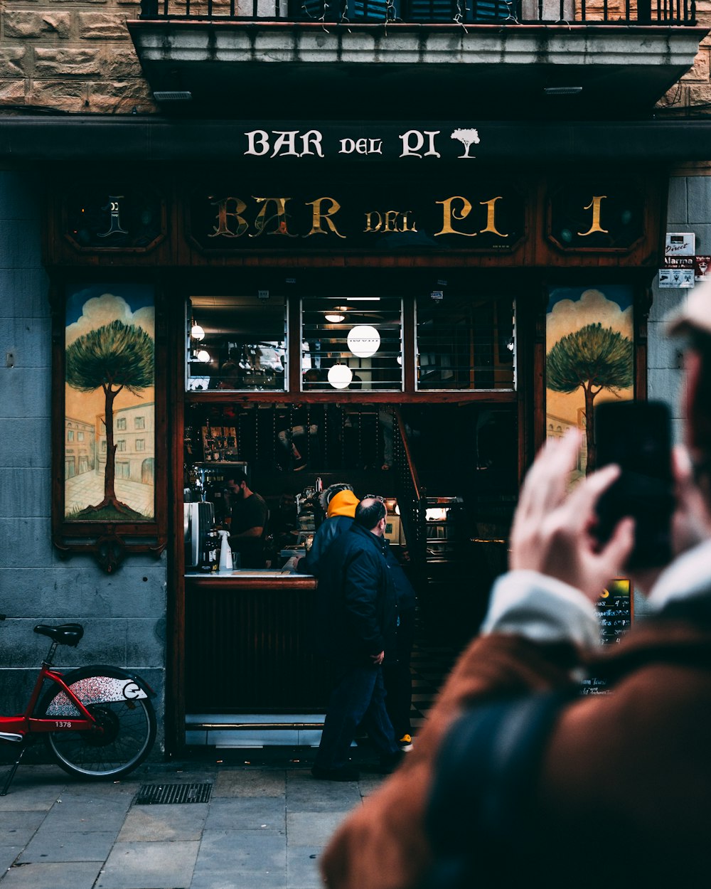 a man taking a picture of a store front