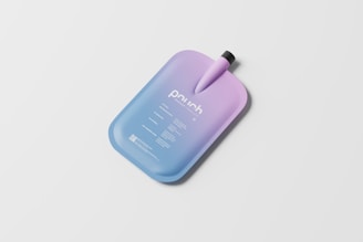 A pouch with a sleek, modern design featuring a gradient color scheme transitioning from blue to lavender. It has a spout at the top with a black cap, and the surface contains printed text detailing product information.