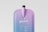 A sleek, modern pouch mockup with a smooth gradient transitioning from purple to blue. The pouch has a tall, slender spout at the top. Simple, clean text is printed on the front, featuring a minimalist design and font.