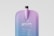 A sleek, modern pouch mockup with a smooth gradient transitioning from purple to blue. The pouch has a tall, slender spout at the top. Simple, clean text is printed on the front, featuring a minimalist design and font.