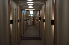 Close-up of saferoom travel™ device scanning a hotel room with a calm, focused ambiance.