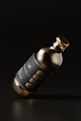 a bottle of wine with a gold cap on a black background