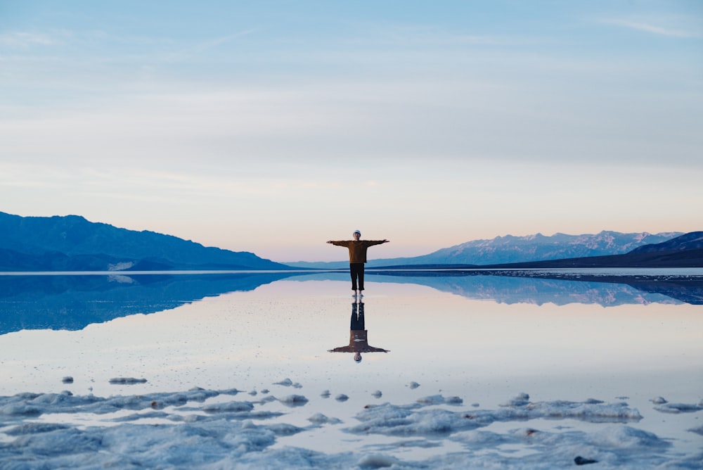 a person standing in the middle of a body of water