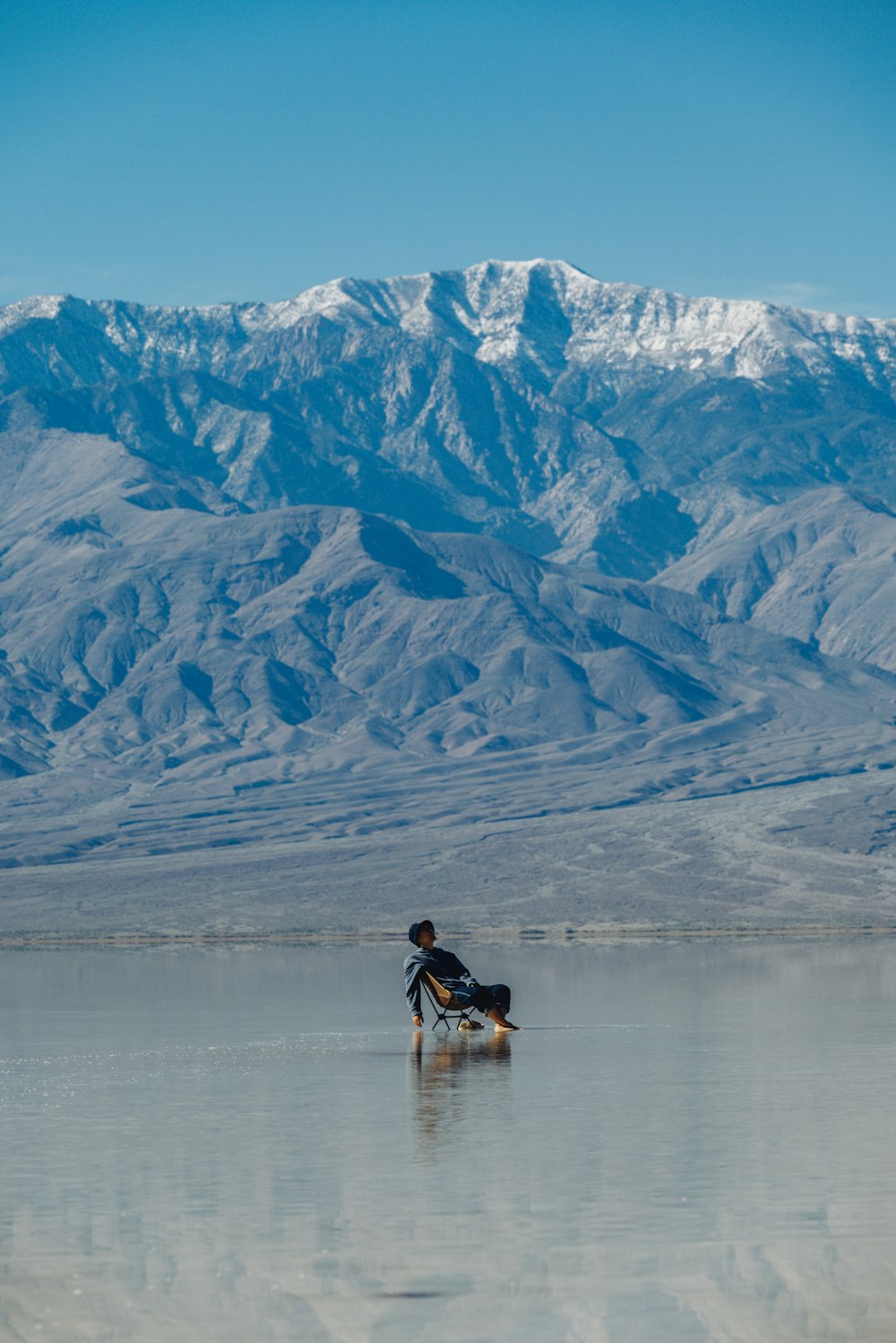 a man riding a surfboard on top of a lake