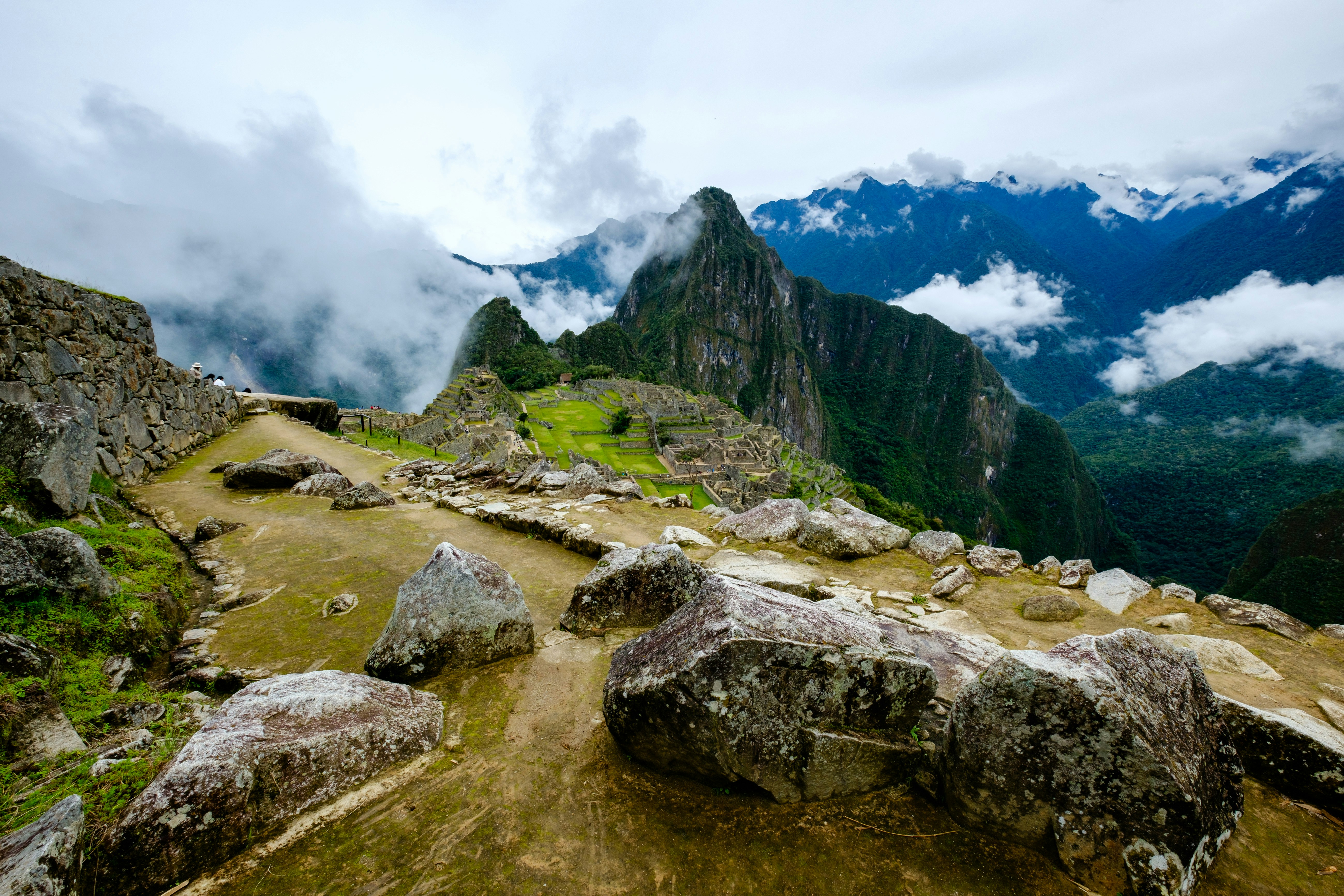 a view of a mountain range with rocks and grass, What is this, a city for ants? It needs to be at least.. 3 times as big!