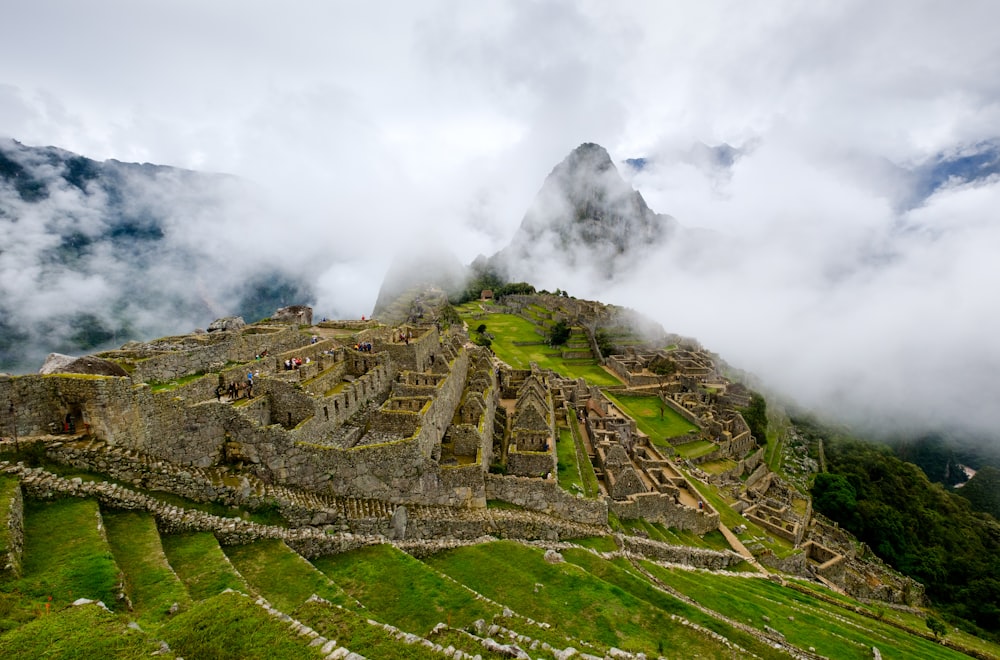 a view of the ruins of a mountain in the clouds