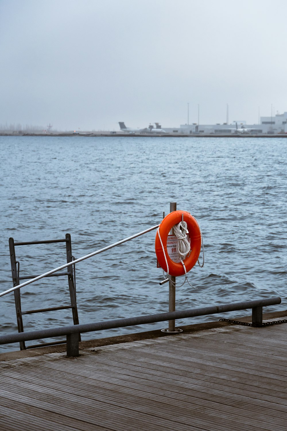 a life preserver on a wooden dock near the water