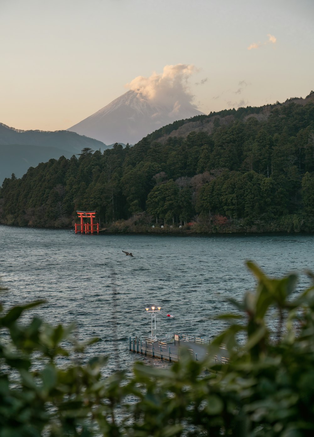 a body of water with a mountain in the background