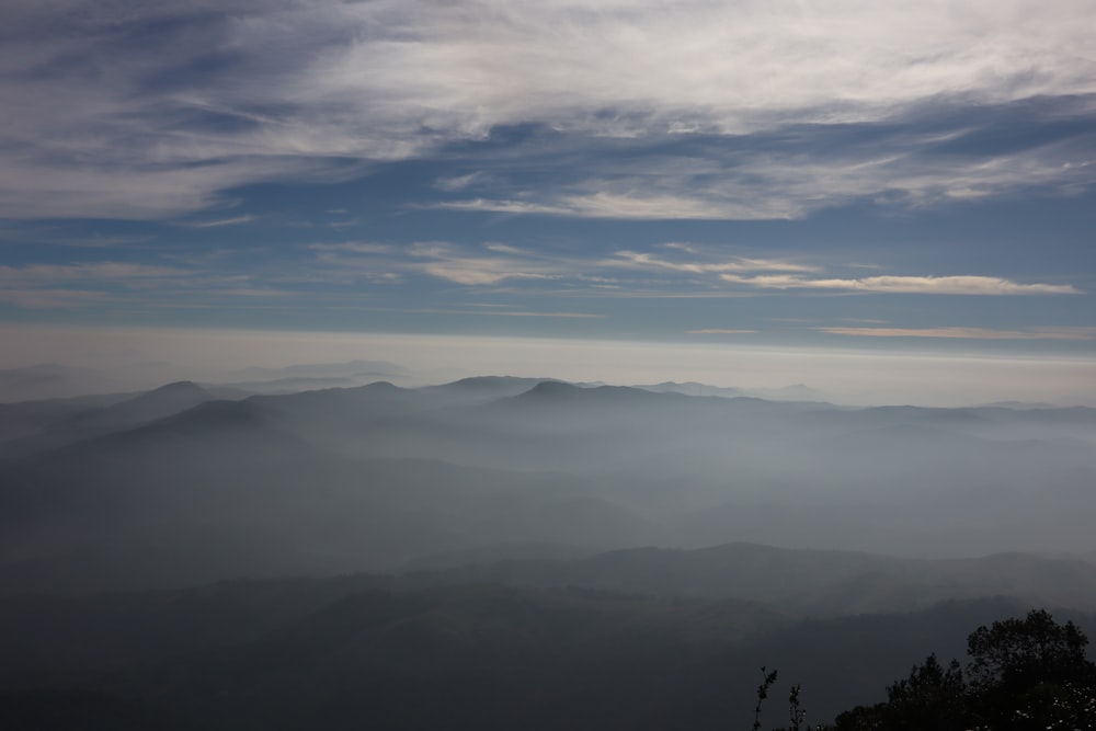 a view of a mountain range covered in fog