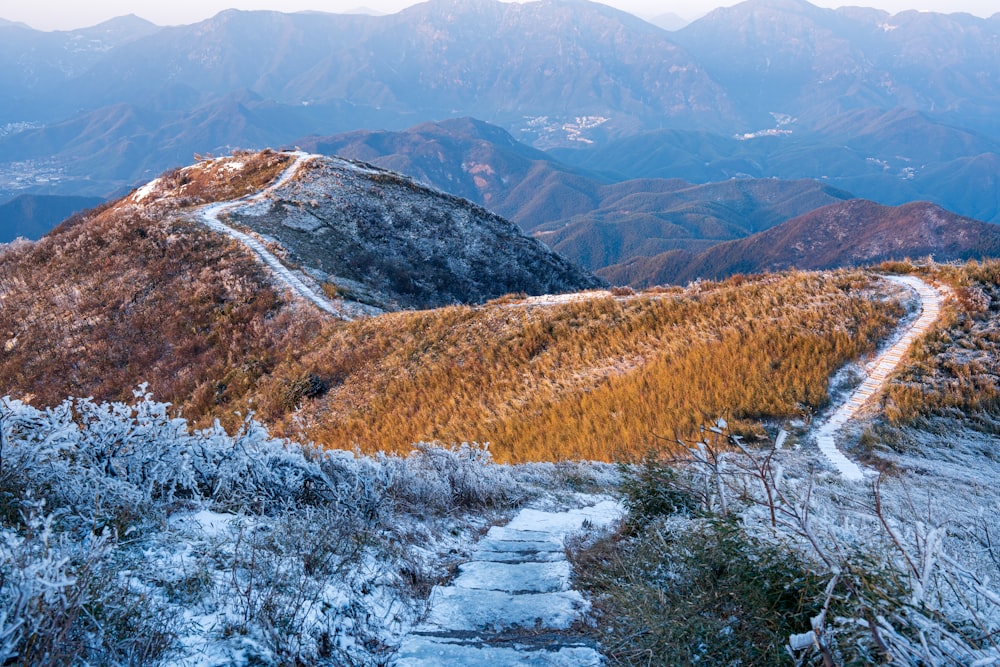 a snow covered mountain with a path going up it