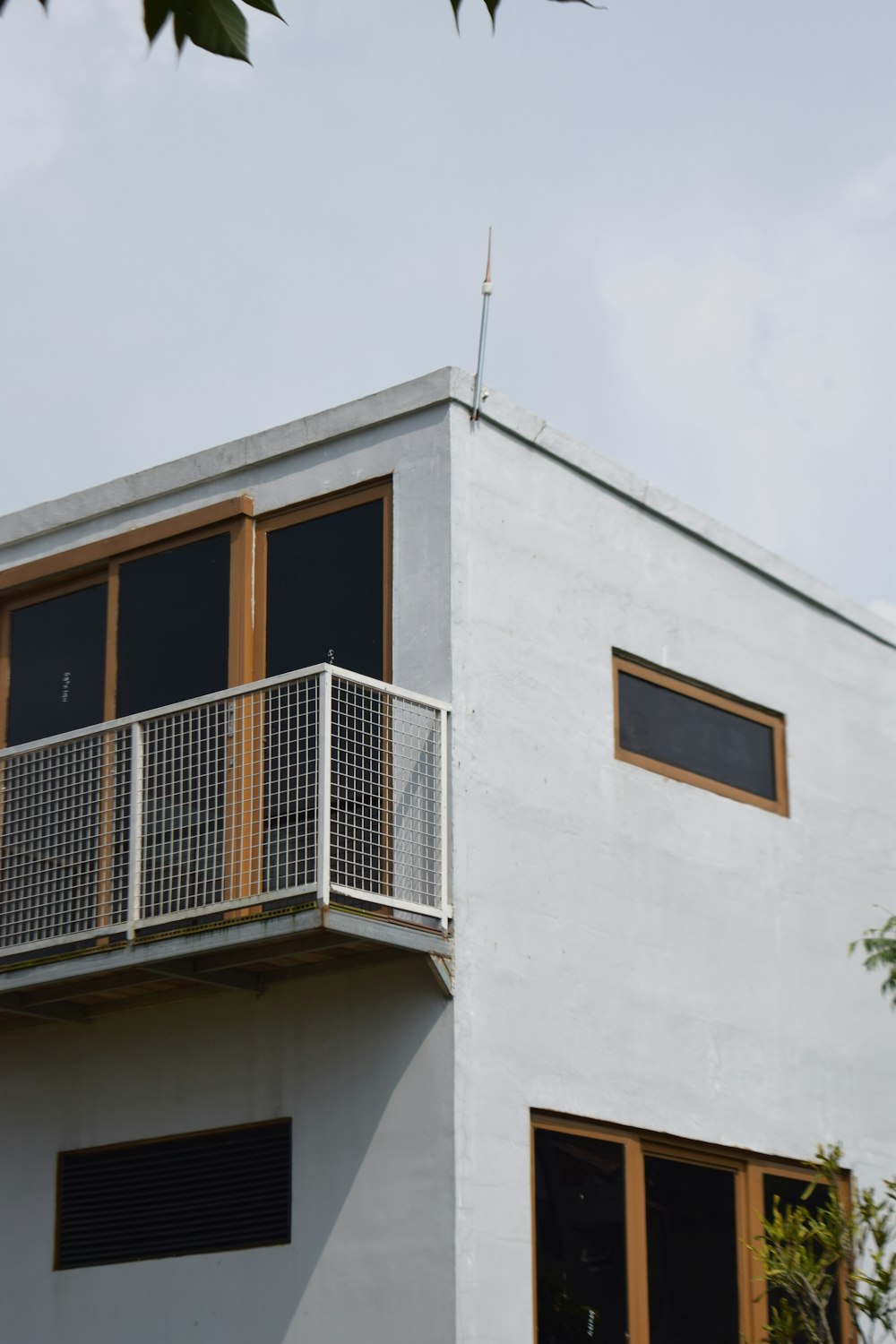 a white house with a balcony and a balcony railing