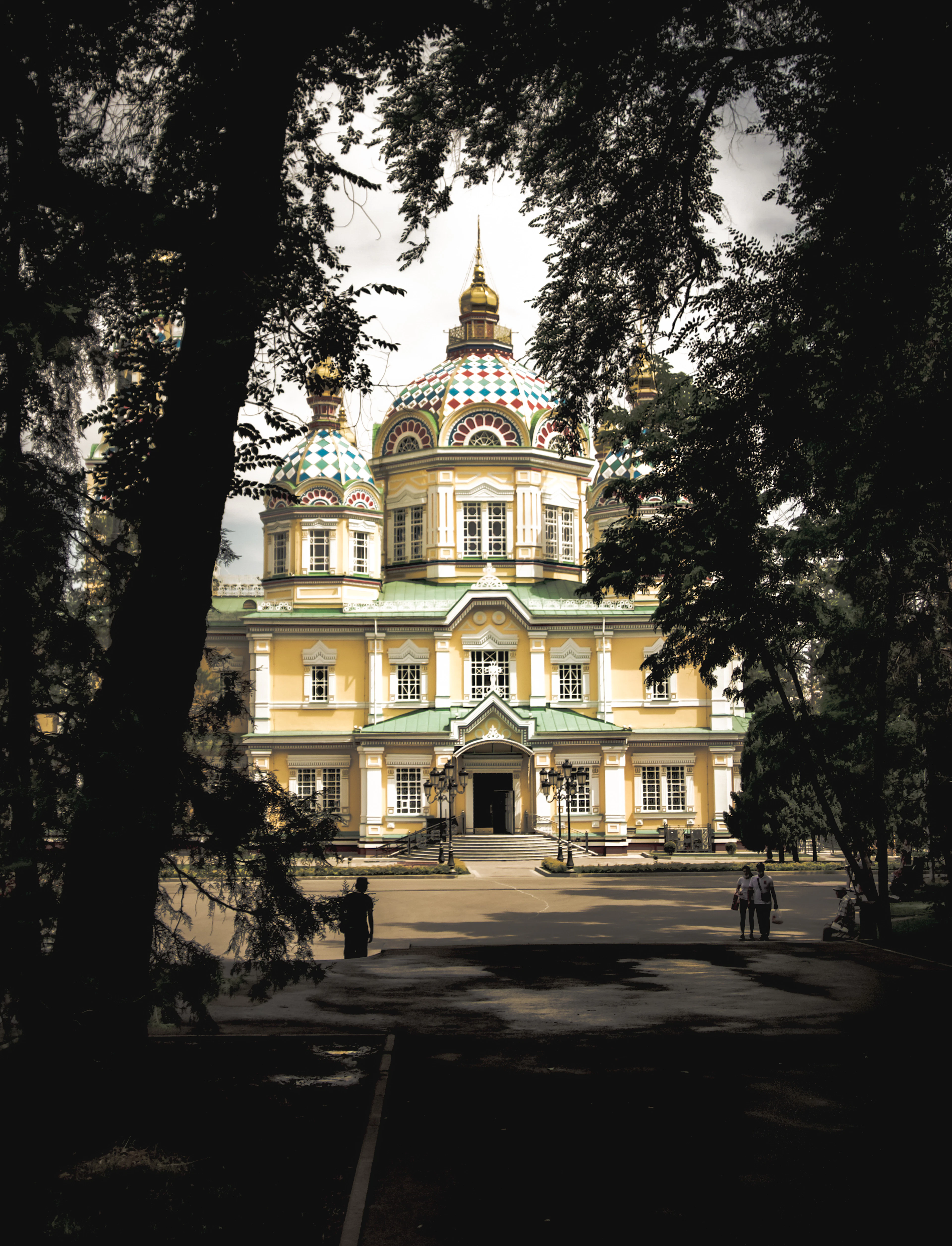 The colorful onion domes of Ascension Cathedral rise above trees in Panfilov Park.