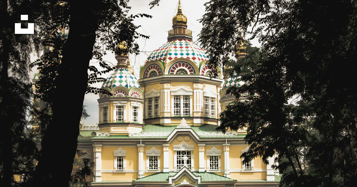 A large yellow building with a green roof photo – Free Almaty Image on ...