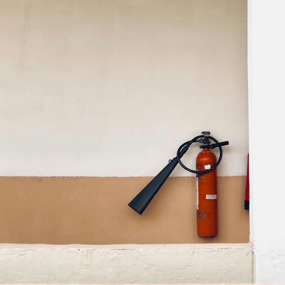 a fire extinguisher is hanging on a wall