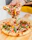 Close-up of a steaming hot pizza slice being lifted from a wooden board.