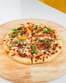 Mini pizzas topped with fresh ingredients ready to be served.