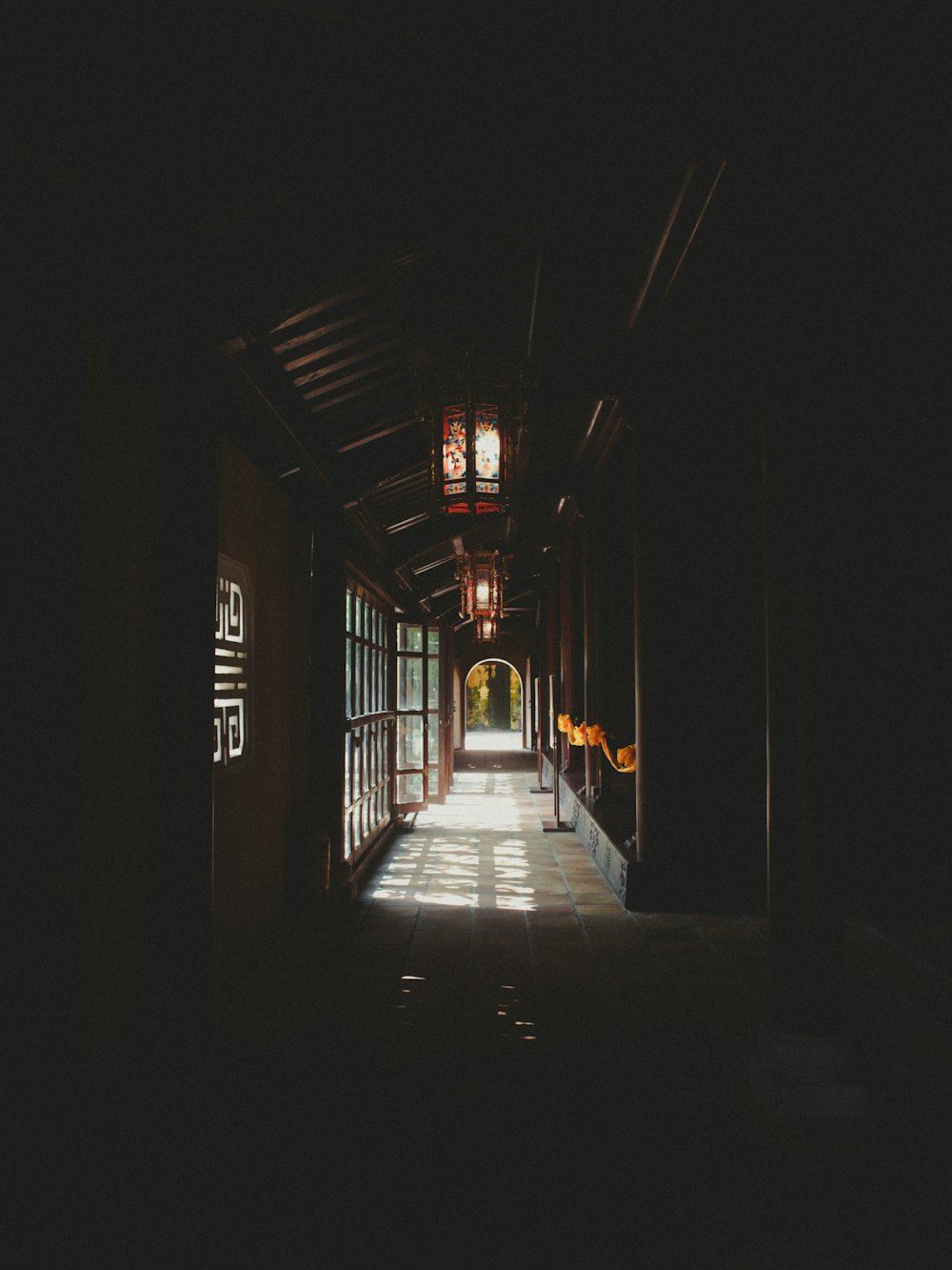 a dark hallway with a clock on the wall