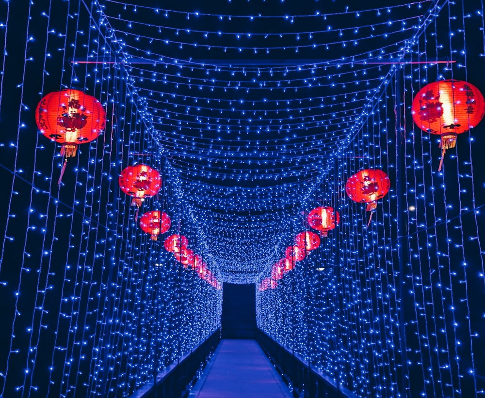 a tunnel of blue lights with red lanterns