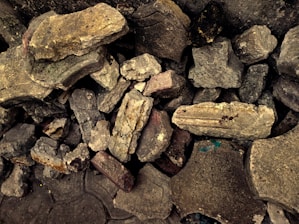 A sturdy rock dumpster filled with concrete and debris.