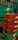 Stacks of green and red plastic crates, with empty glass bottles. The crates are branded with Pepsi and Coca-Cola logos. The bottles are clear and placed in a disorganized manner.