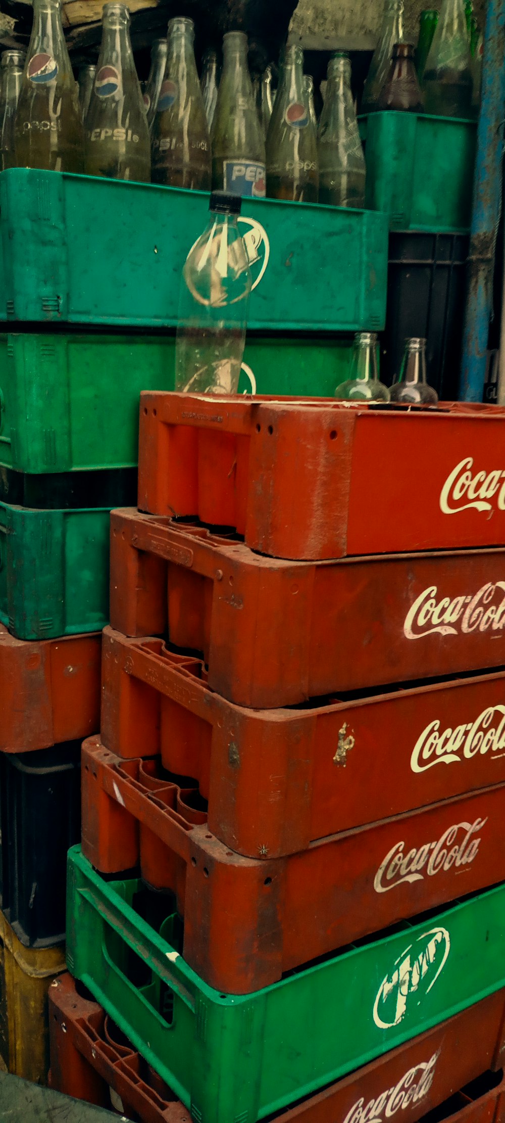 a pile of coca - cola crates stacked on top of each other