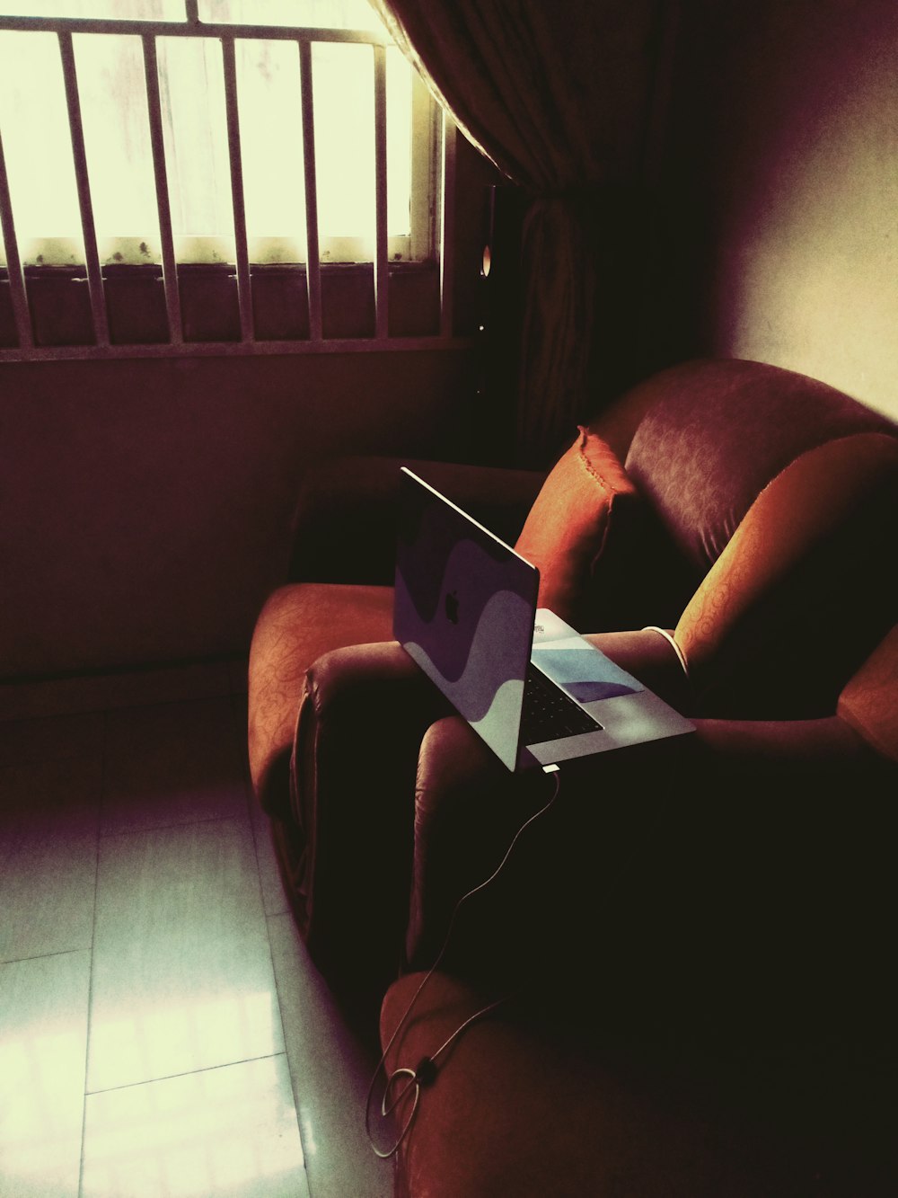 a laptop computer sitting on top of a couch