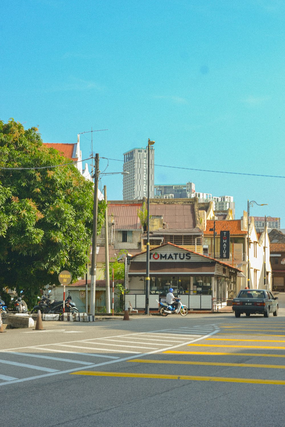 a city street with cars parked on the side of the road