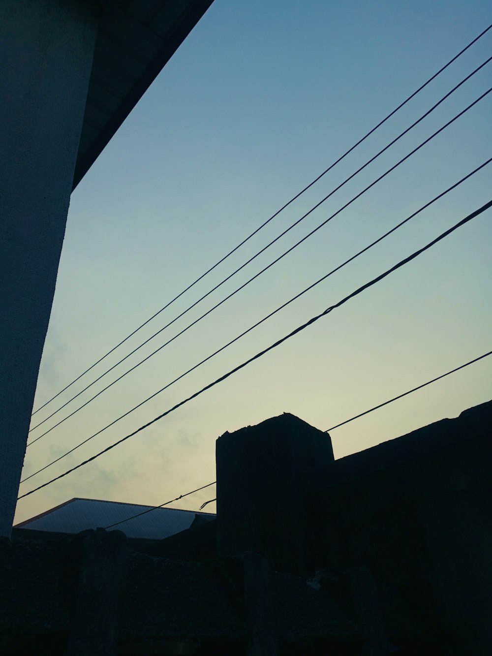 a view of the sky and power lines from a building