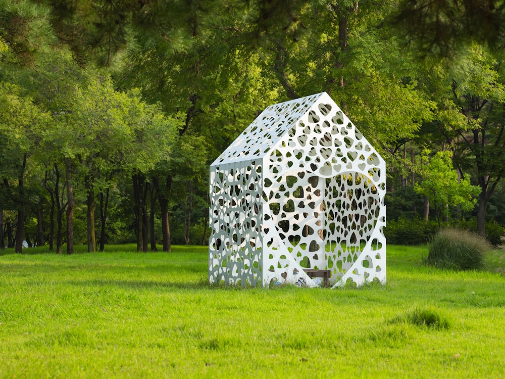 a sculpture of a house made of hearts in a field