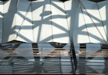 Close-up of architectural shadows and glassmorphism overlays highlighting premium materials and lighting.