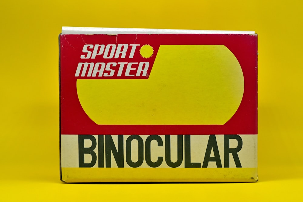 a box of sports master binoculars on a yellow background