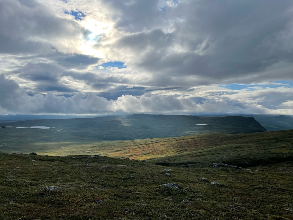 a view of a mountain range with clouds in the sky