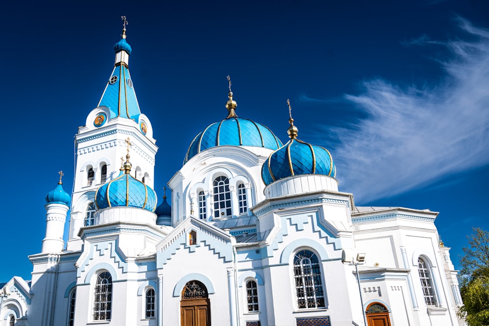 a large white and blue church with two towers