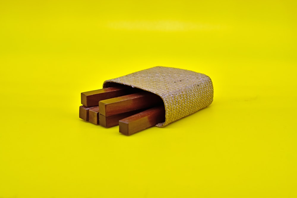 a piece of wood sitting on top of a yellow surface