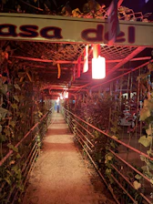A romantic pathway in Quinta de Illescas lined with trees and rustic lanterns leading to the wedding venue.