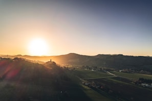 A warm sunset view of Auchenblae church nestled among green fields.