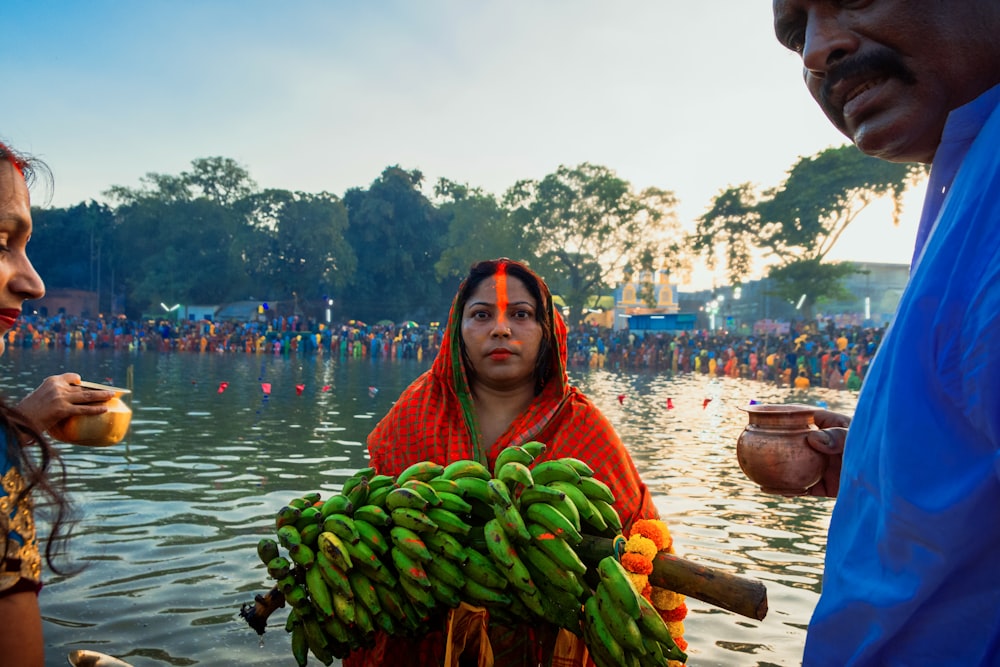 a woman holding a bunch of bananas in her hands